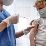 female doctor giving covid 19 vaccine to a toddler